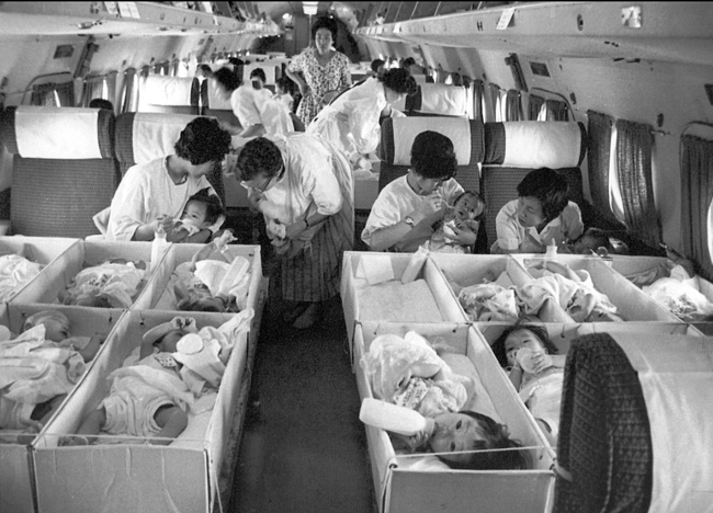 South Korean babies are being sent to the U.S. via plane to be adopted in 1956.Yonhap