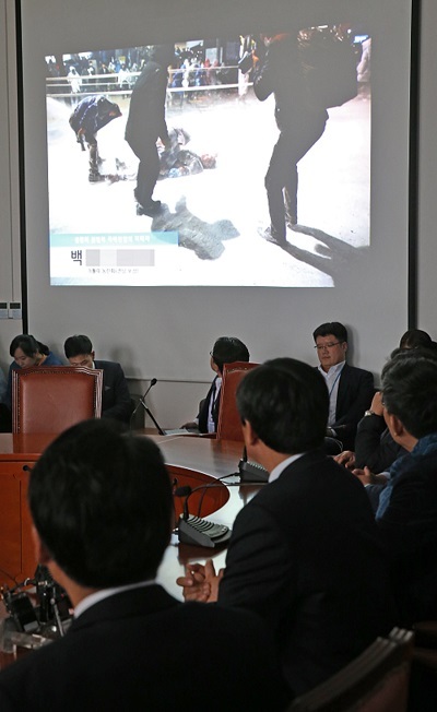 NPAD lawmakers watch a video footage of a protestor being doused with water cannons during the Saturday rally at a party meeting on Monday. (Yonhap)
