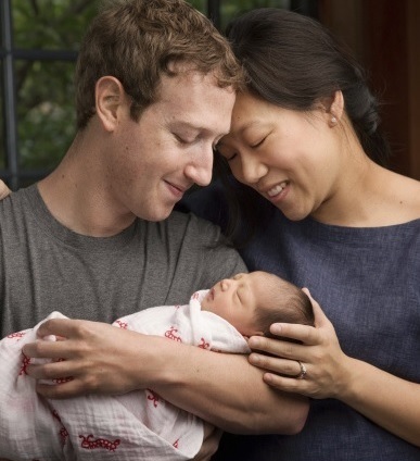 Max Chan Zuckerberg is held by her parents, Mark Zuckerberg and Priscilla Chan Zuckerberg. (AP-Yonhap)