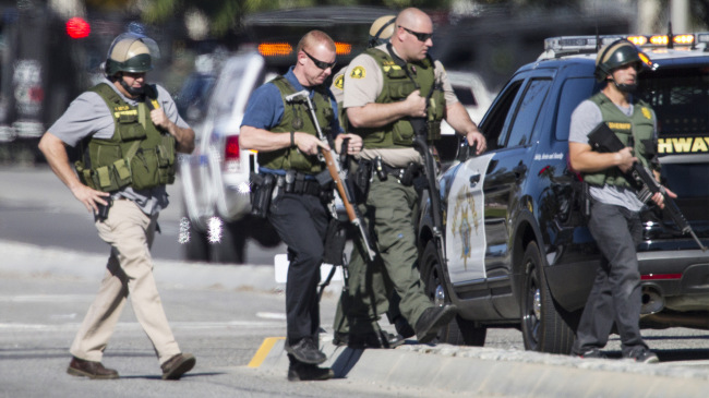 Police officers secure the scene where a mass shooting occurred at the Inland Regional Center in San Bernardino, California, on Dec. 2. Bloomberg