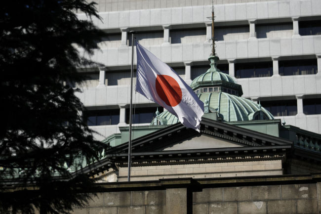 The Japanese national flag flies atop the Bank of Japan headquarters in Tokyo, Japan, on Friday. (Bloomberg)