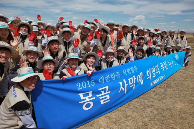 Employees of Korean Air pose for photo after planting trees in the Baganuur Desert in Mongolia. Korean Air