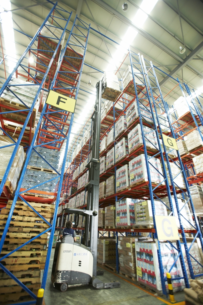 A worker reloads packaged products with a forklift truck at a logistics center in Incheon Port. (Incheon Port Authority)