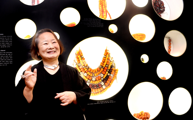 Lee Kang-won, director of the World Jewelry Museum, poses with her ethnic jewelry collection at the museum in Hwa-dong, Seoul. (Park Hyun-koo/The Korea Herald)