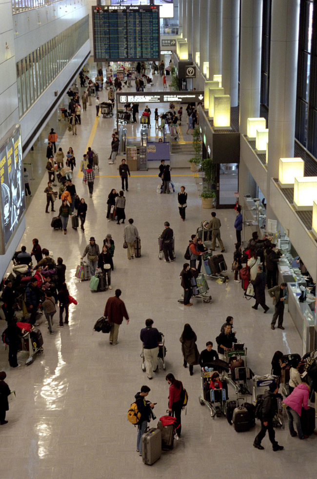 Travelers are seen at Narita Airport. (Bloomberg)