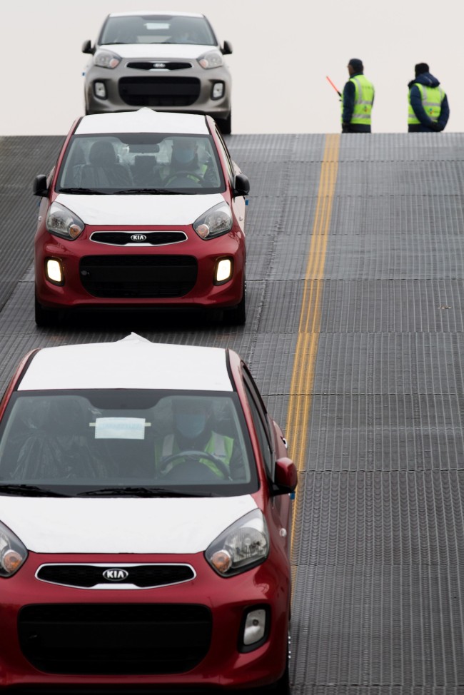 Employees drive Kia Motors’ Picanto vehicles at the port of Pyeongtaek in Pyeongtaek, South Korea. Bloomberg