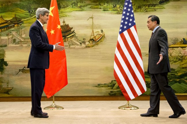 U.S. Secretary of State John Kerry (left) and Chinese Foreign Minister Wang Yi approach to shake hands after attending a news conference at the Ministry of Foreign Affairs in Beijing on Jan. 27. AP-Yonhap