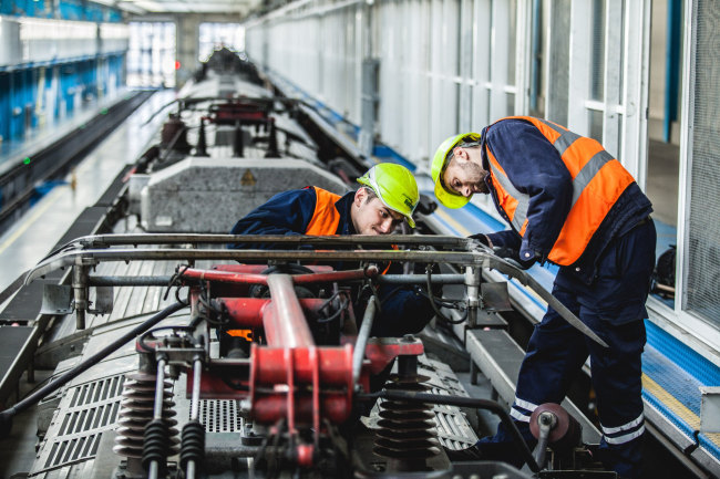 Hyundai Rotem employees repair a railway car in Ukraine. (Hyundai Rotem)