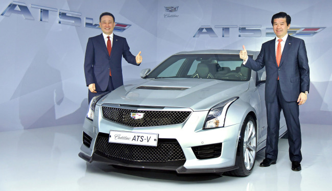 GM LAUNCHES CADILLAC ATS-V -- James Kim (right), president & CEO of GM Korea, and Chang Jae-joon, president of GM Korea and representative director of Cadillac, pose with the Cadillac ATS-V at the launch event held in southern Seoul on Wednesday. The compact premium performance sedan is equipped with a 3.6-liter V6 twin turbo engine that boasts maximum 470 horsepower output and 61.4 kilogram-meters torque. The car starts from 79.5 million won ($64,400).(Yonhap)