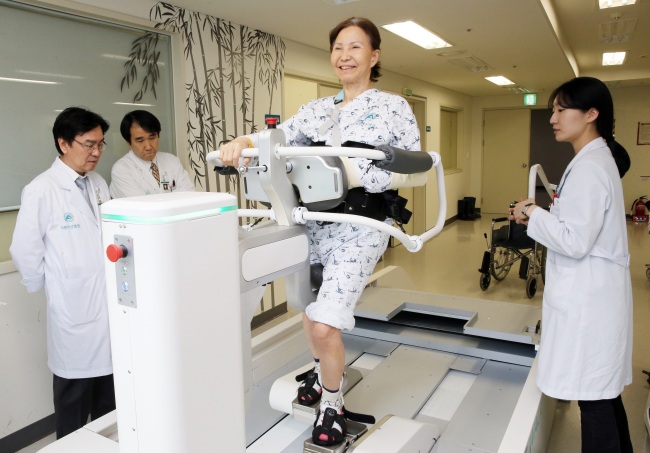 ROBOT HELPING REHABILITATION -- Hyundai Heavy Industries said Thursday that it started to provide robots helping patients‘ rehabilitation to Seoul Asan Medical Center. (HHI)