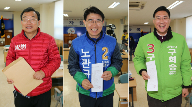 Candidates Rep. Lee Jung-hyun (from left) of the Saenuri Party, Noh Gwan-gyu of The Minjoo Party of Korea and Koo Hee-seung of the People’s Party leave after registering themselves with the election commission office at Suncheon, South Jeolla Province, Thursday. (Yonhap)