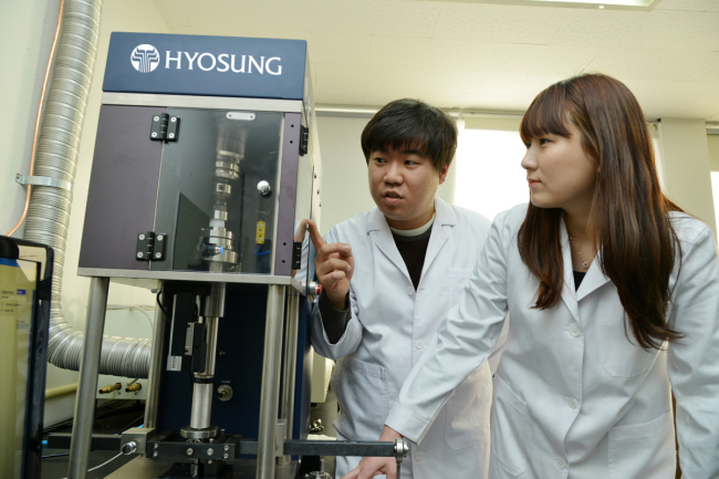 Hyosung’s researchers conduct an experiment on polyketone material. (Hyosung)