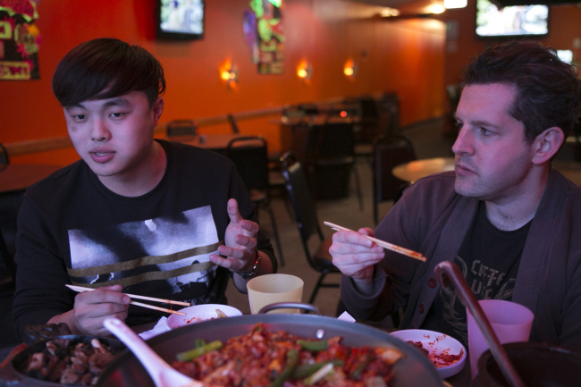 Deuki Hong (left) and Matt Rodbard, authors of the cookbook “Koreatown,” talk over dinner at Dancen in Chicago‘s Lincoln Square neighborhood. (Chicago Tribune/TNS)