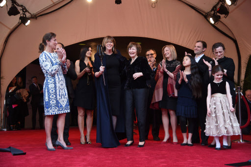 Producer Jane Rosenthal, Susan Zuccotti and the Zuccotti family cut the ribbon during the “The First Monday In May” world premiere at the 2016 Tribeca Film Festival opening night ceremony held at John Zuccotti Theater at BMCC Tribeca Performing Arts Center on Wednesday in New York City. (AFP-Yonhap)