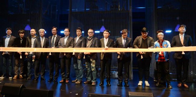 Artists, scholars and representatives from CJ Group, including Byun Dong-shik, head of corporate responsibility at CJ Group (fourth from right), attend the ribbon-cutting ceremony for the opening of CJ Azit Daehangno on Friday. (CJ Group)