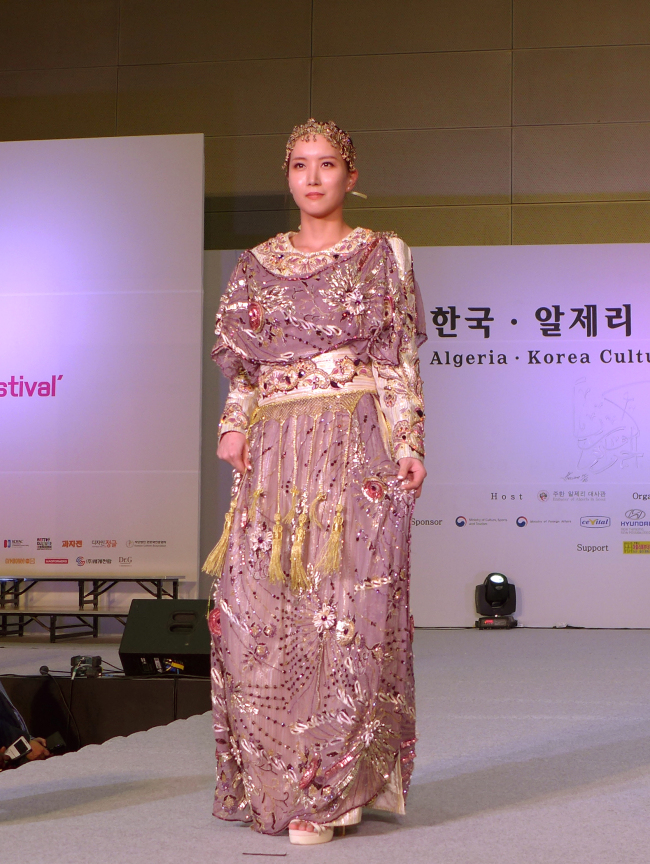 A model showcases a newly interpreted traditional dress by Algerian designer Samir Kerzabi on stage at Coex in Seoul on Thursday. (Joel Lee / The Korea Herald)