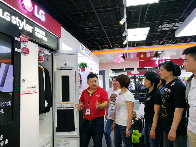 Customers check out an LG Styler at a shop in Beijing. (LG Electronics)