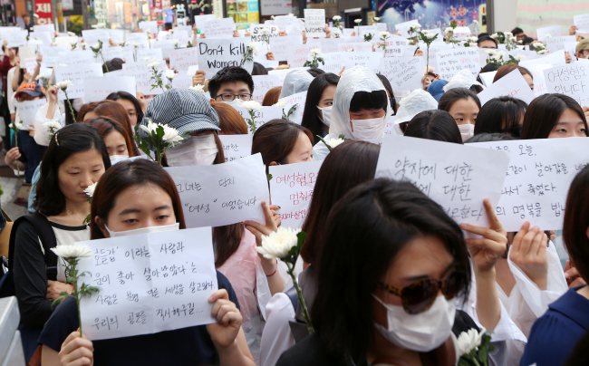 Participants attend a tribute march for the victim of the Gangnam murder on Saturday. (Yonhap)