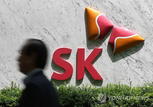 A person passes by the logo of SK Group. (Yonhap)