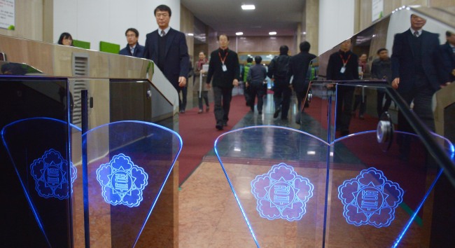 Civil servants enter the government complex in Seoul. The Investor