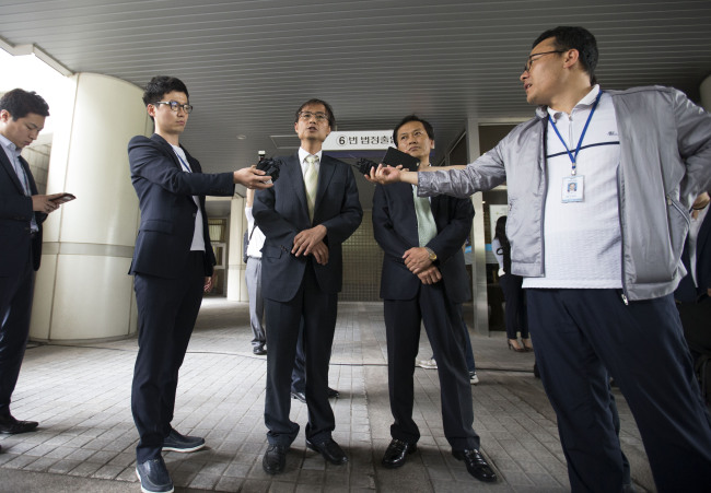 Members of Lawyers for a Democratic Society speak with reporters at the Seoul Central District Court on Tuesday. (Yonhap)