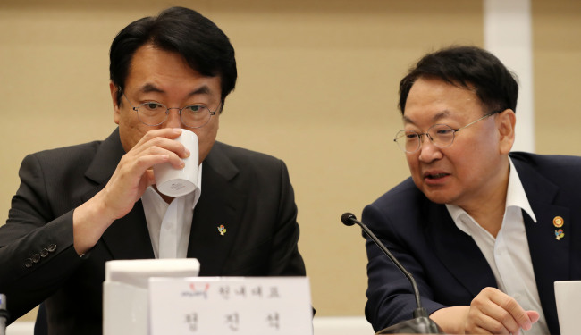 Finance Minister Yoo Il-ho(right) talks to the ruling Saenuri Party floor leader Rep. Chung Jin-suk.     Park Hae-mook/The Investor