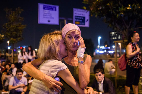 Passengers embrace outside Ataturk airport`s main enterance in Istanbul. (Yonhap-AFP)