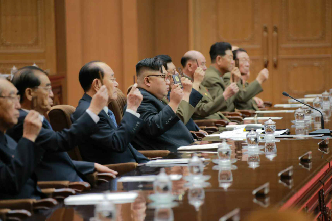 North Korean leader Kim Jong-un (fourth from left) is inducted as chairman of the newly State Affairs Commission during a session of the Supreme People’s Assembly on Wednesday in an image carried Thursday by the Rodong Sinmun. (Yonhap)