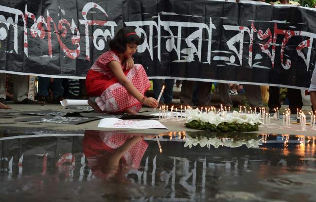 Indian social activists light candles during a protest in Kolkata on Saturday against a fatal attack on a restaurant in the Bangladeshi capital Dhaka. Heavily armed militants murdered 20 hostages in Bangladesh, hacking many of their victims to death, before six of the attackers were gunned down at the end of a siege July 2 at a restaurant packed with foreigners. (AFP-Yonhap)