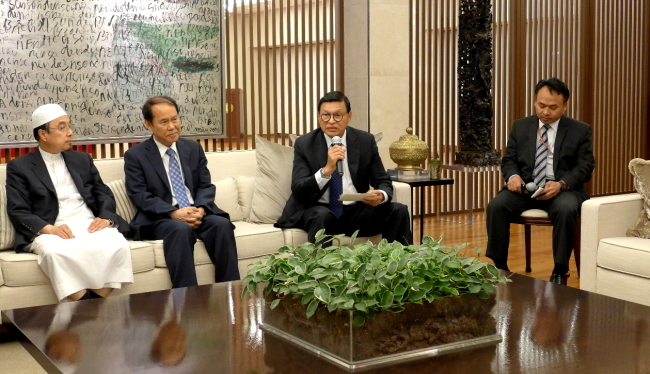 Indonesian Ambassador John Prasetio (second from right) speaks at the embassy to mark the end of Ramadan before the 