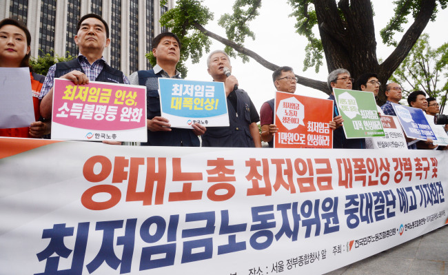 Debate continues over minimum wage increase in South Korea. / The Investor