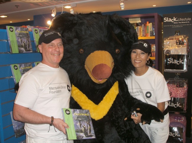 Gina Moon and her husband John William Walker with “Ura‘s World,” a book written by Walker as part of their campaign to protect bears and end bear bile farming. (Moonbears.org)