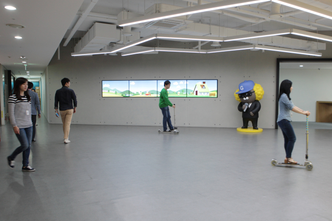 Pangyo-based Kakao employees ride around the company on kickboards.