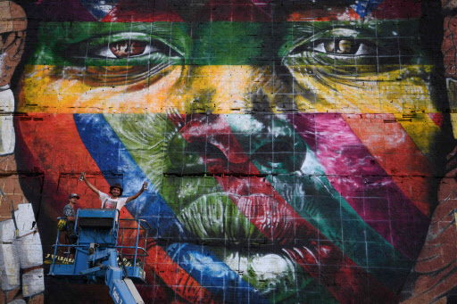 Assistants of Brazilian artist Eduardo Kobra work on the painting of a huge mural representing the five continents, at the Olympic Boulevard, in Rio de Janeiro, Brazil, on July 14. (AFP-Yonhap)