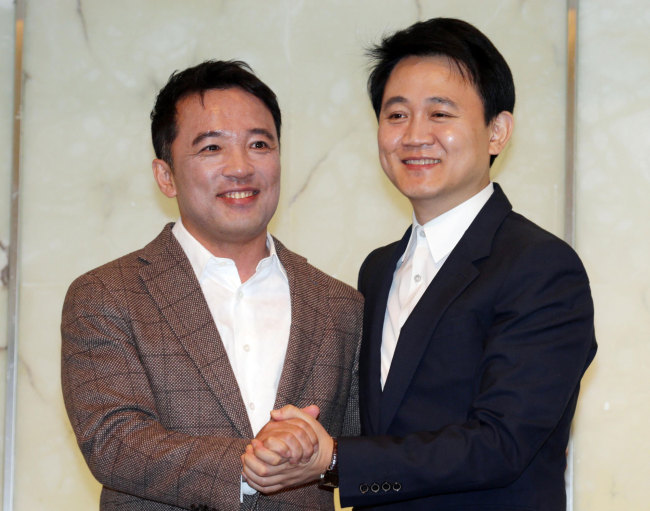 NCSOFT CEO Kim Taek-jin (left), Netmarble Games chief Bang Joon-hyuk  /  NCSOFT