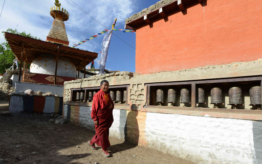 A Nepalese monk walks past a stupa (chorten) at Ghemi village in Lo Manthang in Upper Mustang on June 14. (AFP-Yonhap)