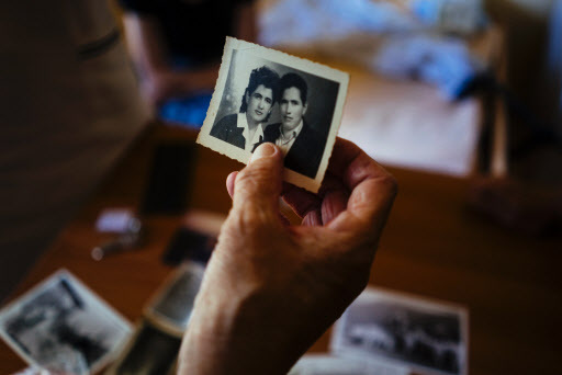 Shkurtan Hasanpapaj, 84, a “sworn virgin,” looks at old photographs in her room in the women’s ward of a hospital in the northern Albanian city of Shkodra on June 27. (AFP-Yonhap)