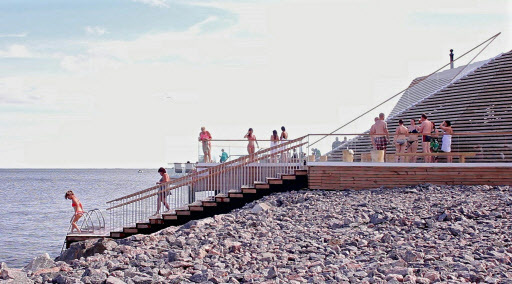 Sauna-goers dip in the Baltic Sea at the trendy new boutique sauna Loyly in Helsinki, on July 7. (AFP-Yonhap)