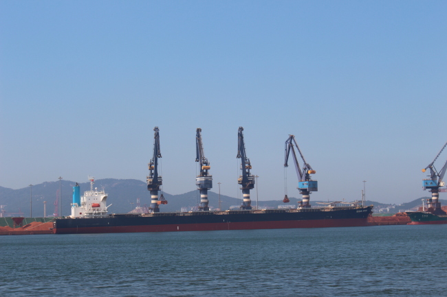 A freighter is seen at a port in Yantai. (Yoon Min-sik/The Korea Herald)