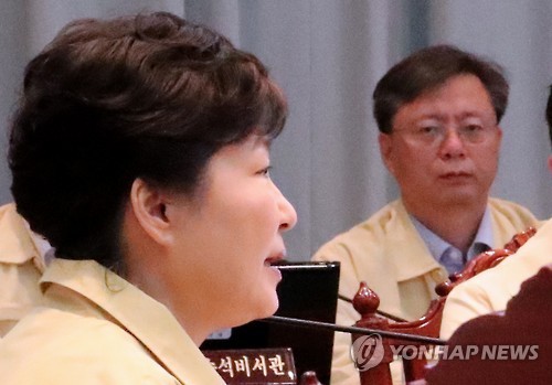 President Park Geun-hye speaks as her senior secretary for civil affairs Woo Byung-woo watches during the Cabinet meeting on Monday. (Yonhap)