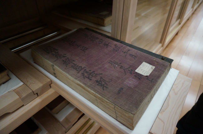 “Uigwe,” a book on the royal protocols of Joseon, is stored in a wooden drawer in the storage vault of the National Palace Museum of Korea. (Lee Woo-young/The Korea Herald)