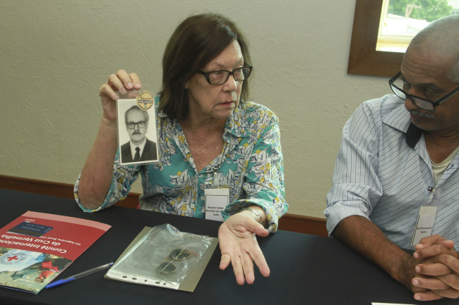 A woman shows a photo of her father who disappeared during a period of military dictatorship (1964-85) in Brazil. (The International Committee of the Red Cross)