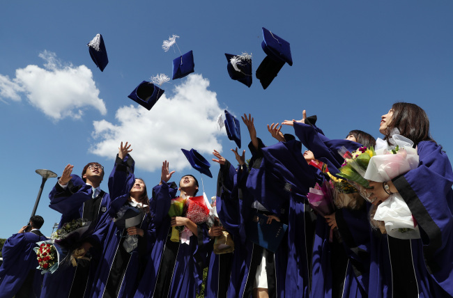 Students celebrate their graduation at Seoul National University in Seoul on Monday. (Yonhap)