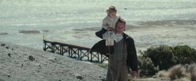 Tom Sherbourne (Michael Fassbender) holds the child Lucy (Florence Clery) in “The Light Between Oceans.” (Davi Russo/Dreamworks II Distribution Co.)