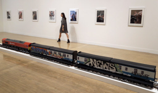 A woman walks past part of an artwork by Josephine Pryde, one of the four artists shortlisted for the Turner Prize 2016, as it is displayed at the Tate Britain gallery in London, Monday. (AP-Yonhap)