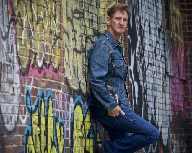 Photographer Mark Seliger poses near the corner of Christopher and Weehawken Streets, in the vicinity of his West Village studio in New York on Sept. 28. (AP-Yonhap)