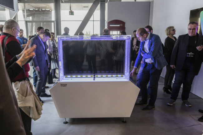 Visitors gather at the Samsung's quantum dot display technology exhibition at the Copernicus Science Center in Poland. Samsung Electronics