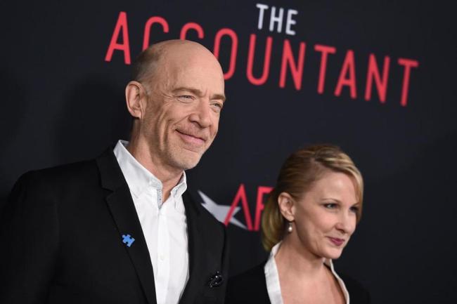 J.K. Simmons (left) and Michelle Schumacher arrive at the world premiere of “The Accountant” at the TCL Chinese Theatre on Monday, Oct. 10, 2016, Los Angeles. (AP)