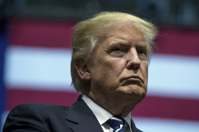 President-elect Donald Trump stands on stage during a rally at DeltaPlex Arena in Grand Rapids, Michigan on Friday. (AP)