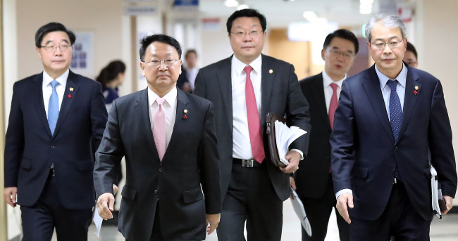 Finance Minister Yoo Il-ho (second from left) and other officials walk together on the way to a joint press conference held at the Seoul Government Complex on Thursday. (Yonhap)